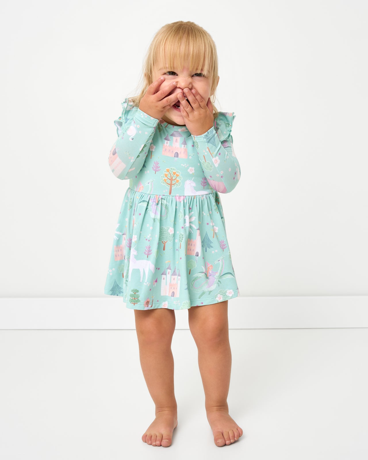 Posing girl wearing the Enchanted Fairytale Flutter Twirl Dress with Bodysuit