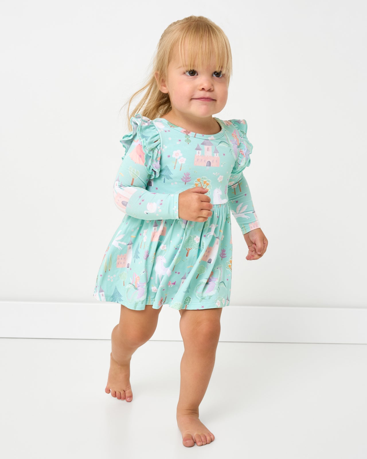 Running toddler wearing the Enchanted Fairytale Flutter Twirl Dress with Bodysuit