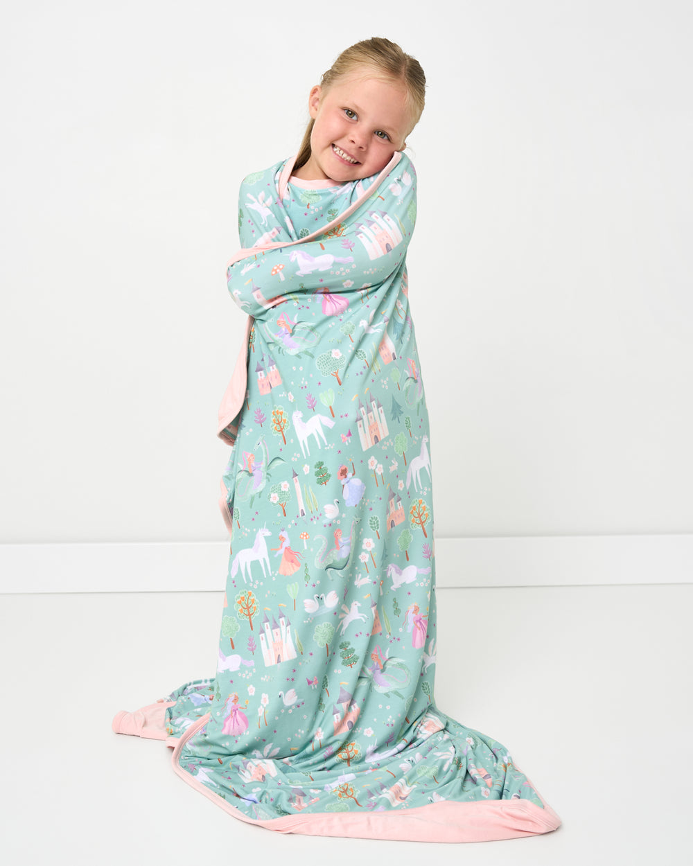 Girl wrapped in the Enchanted Fairytale Large Cloud Blanket®