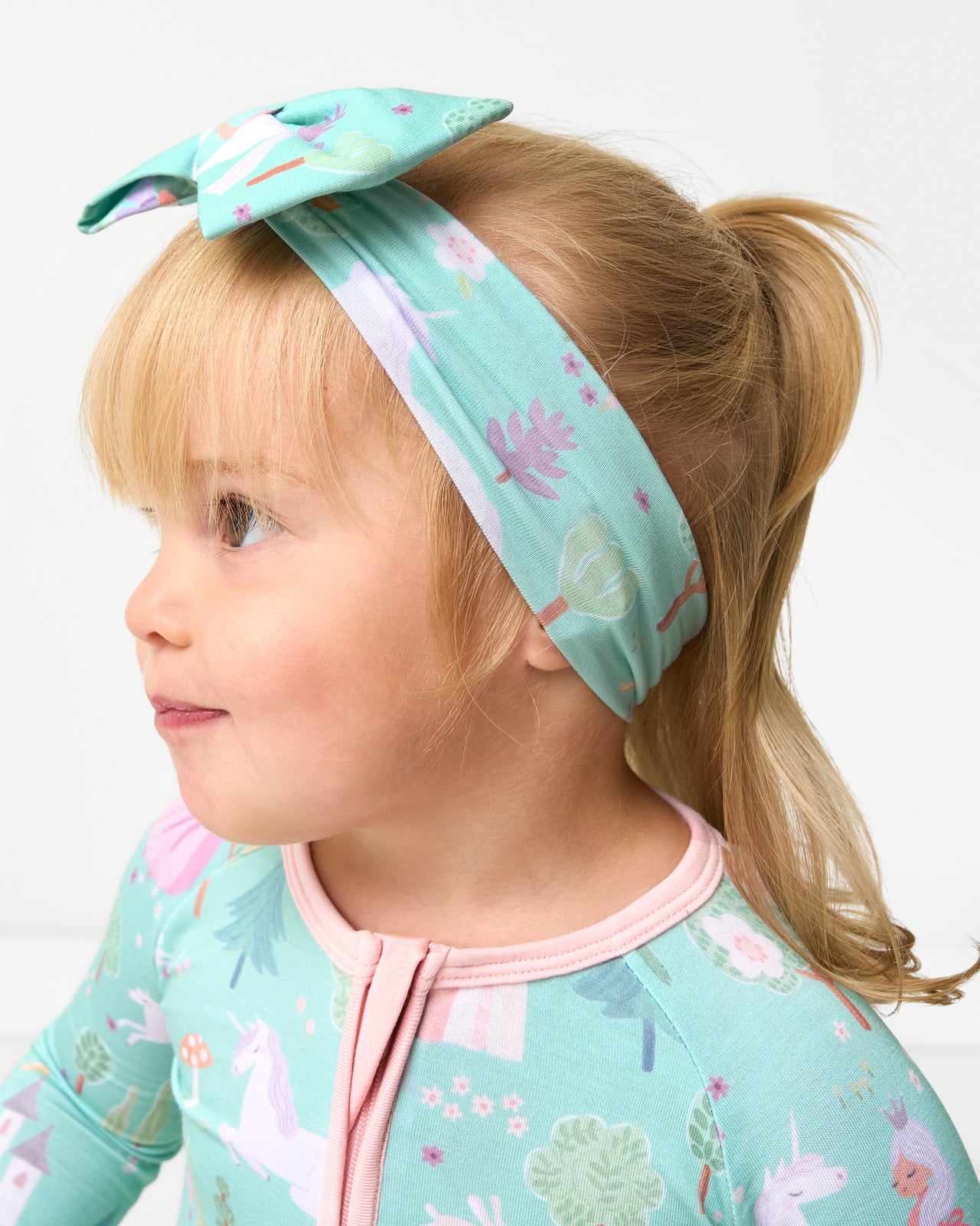 Side view of toddler wearing the Enchanted Fairytale Luxe Bow Headband
