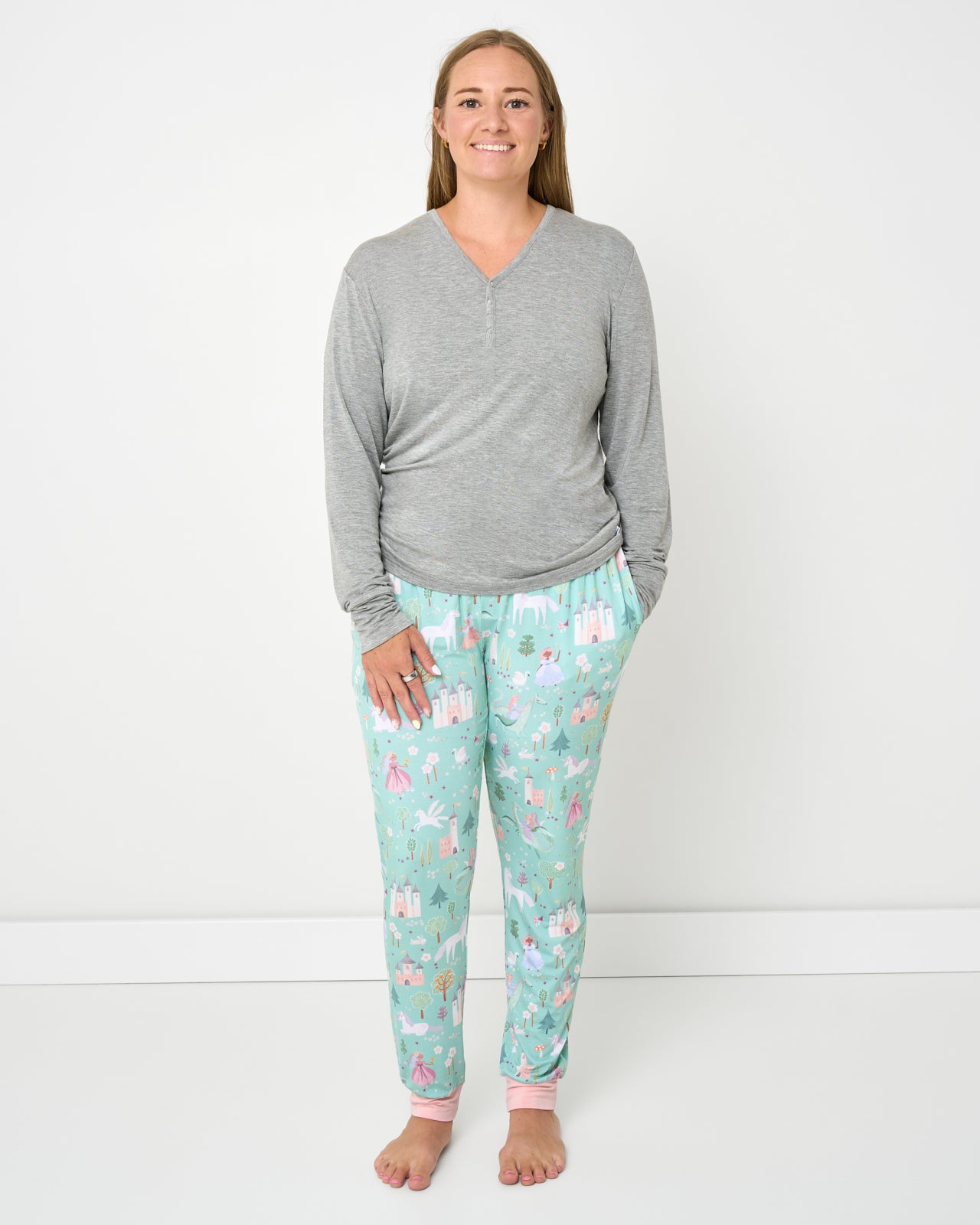Woman wearing the Enchanted Fairytale Women's Pajama Pants with a gray pajama top