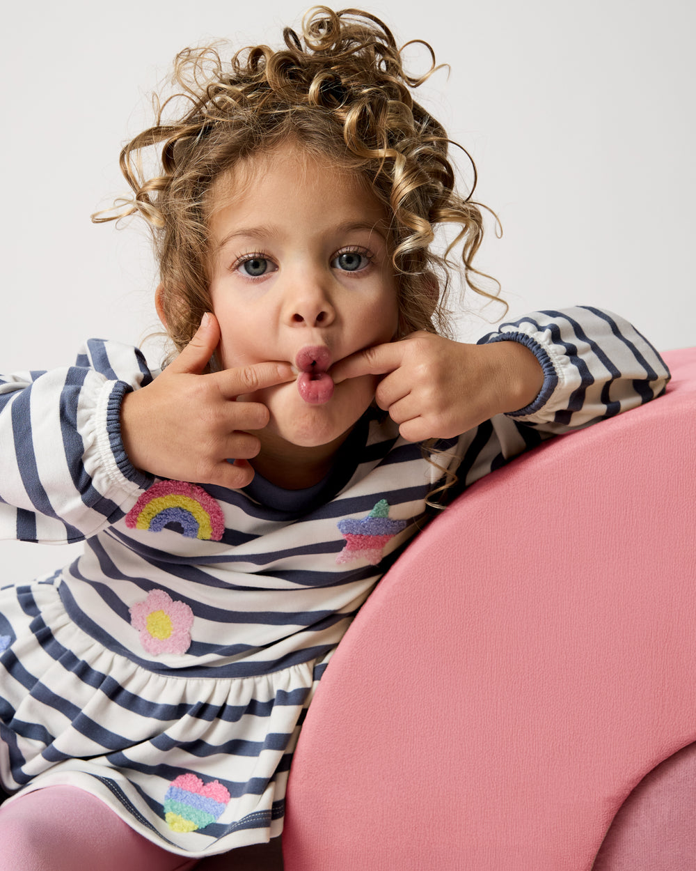 Posing girl wearing the Hazy Blue Stripe Puff Sleeve Peplum Top