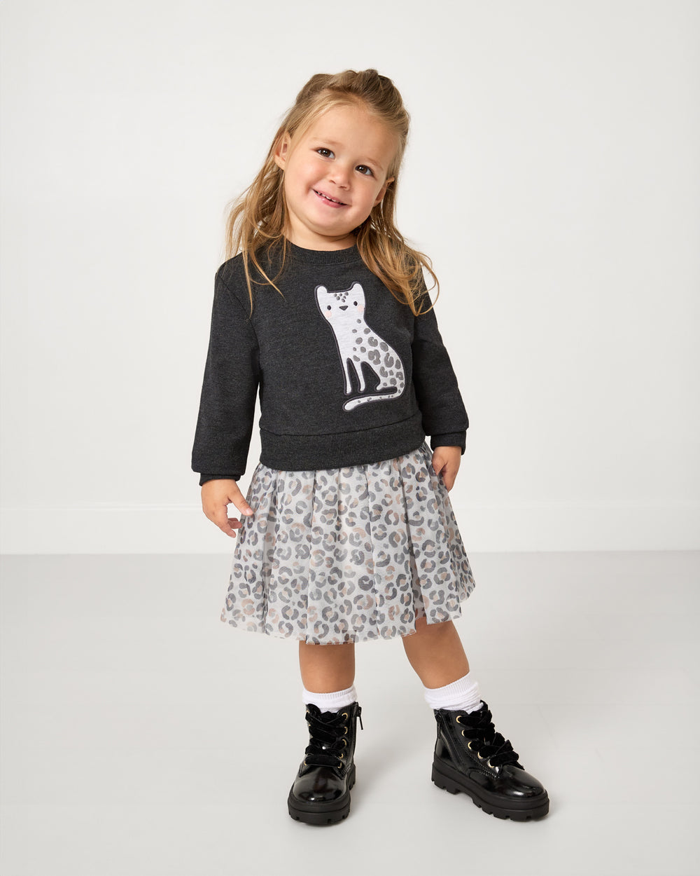 Girl wearing the Snowy Leopard Crewneck Tutu Dress with leather boots