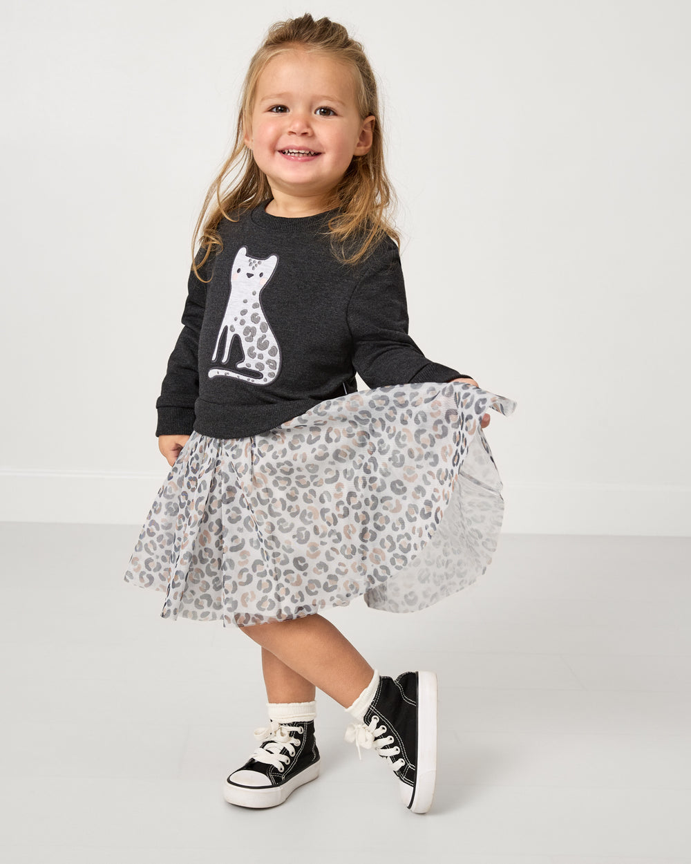 Posing girl wearing the Snowy Leopard Crewneck Tutu Dress