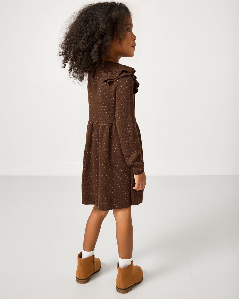 Back view of girl wearing the Mocha Ruffle Sweater Dress