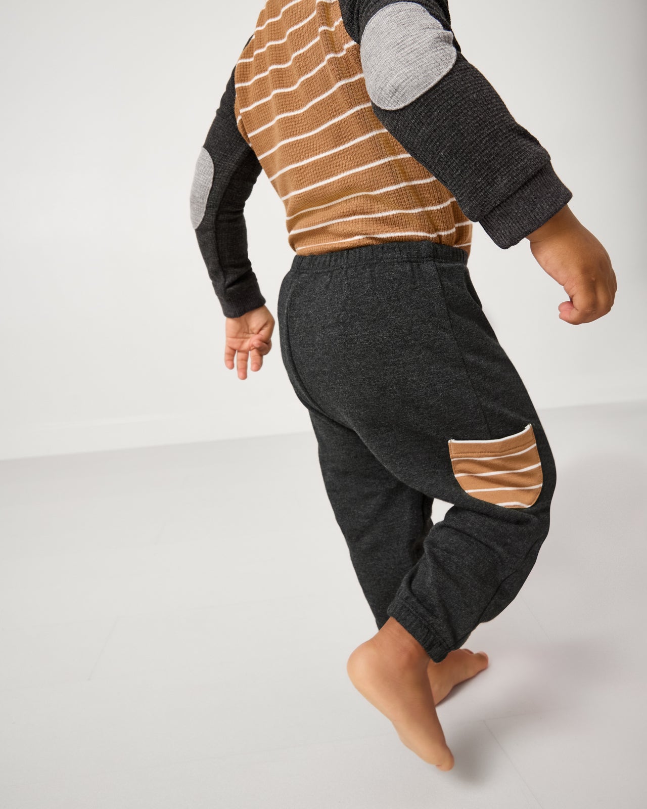 Walking child wearing the Heather Black Cinched Jogger