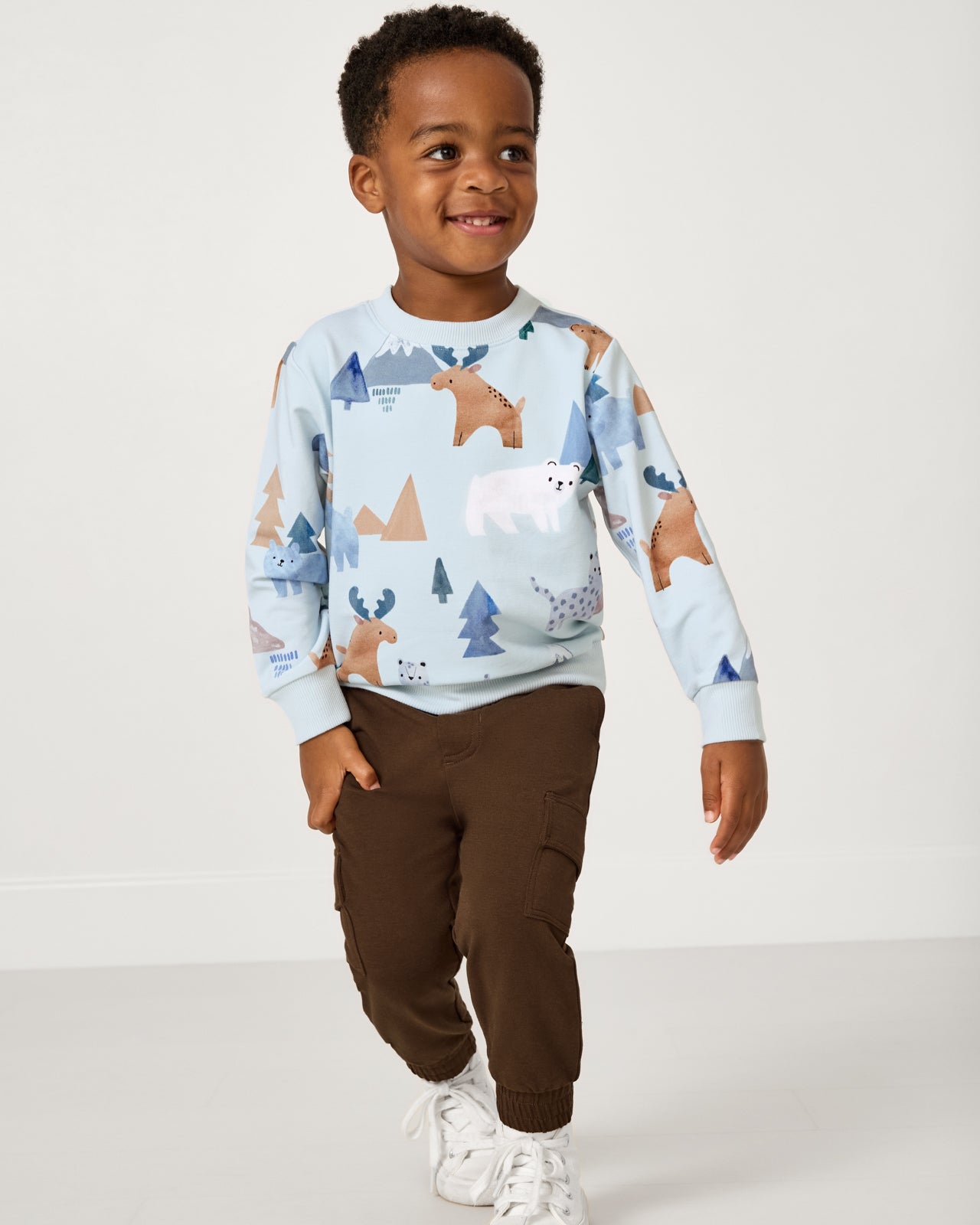 Boy wearing the Mocha Cargo Jogger with a winter themed sweatshirt