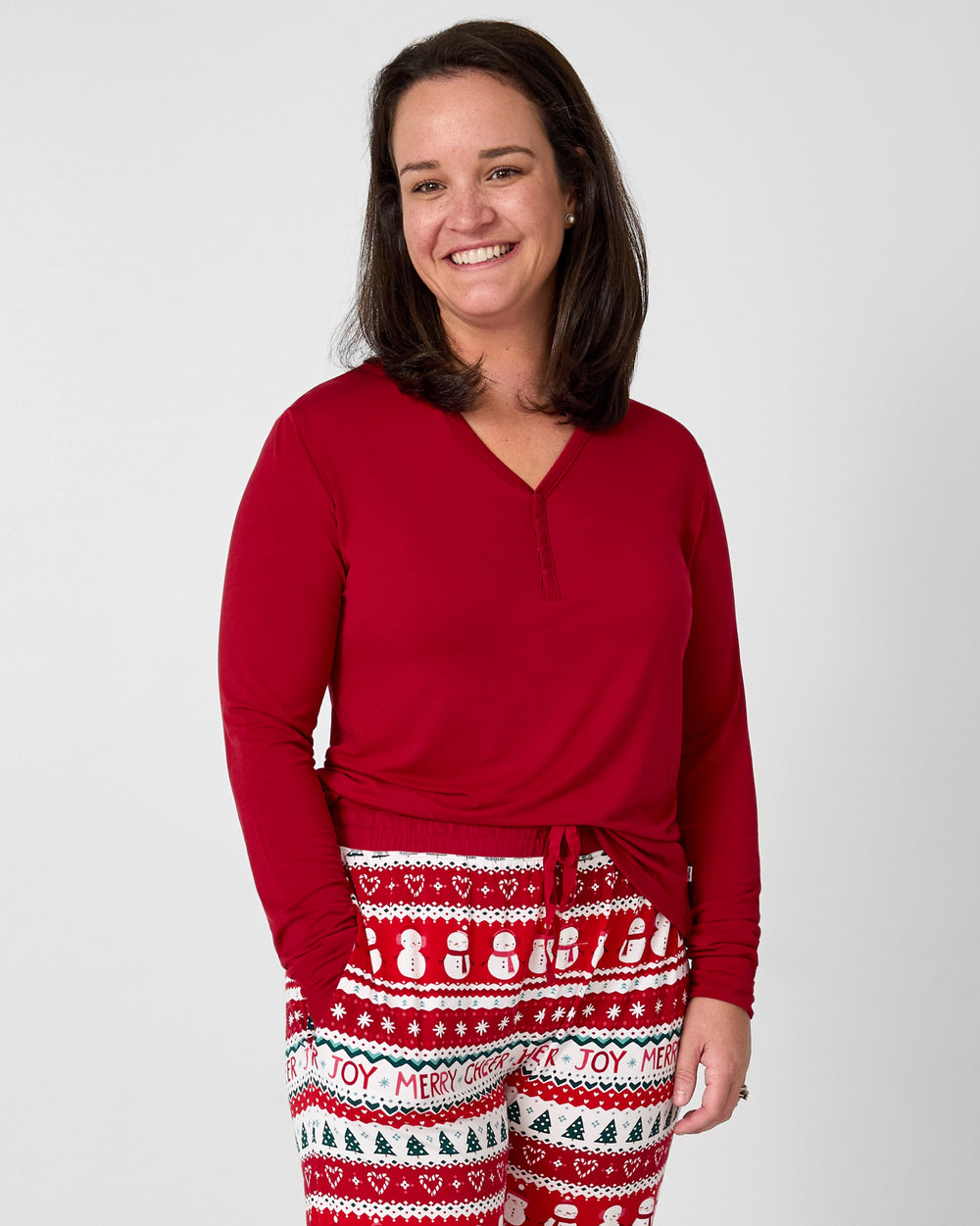 Woman wearing the Holiday Red Women's Long Sleeve Pajama Top with Festive Fair Isle pants