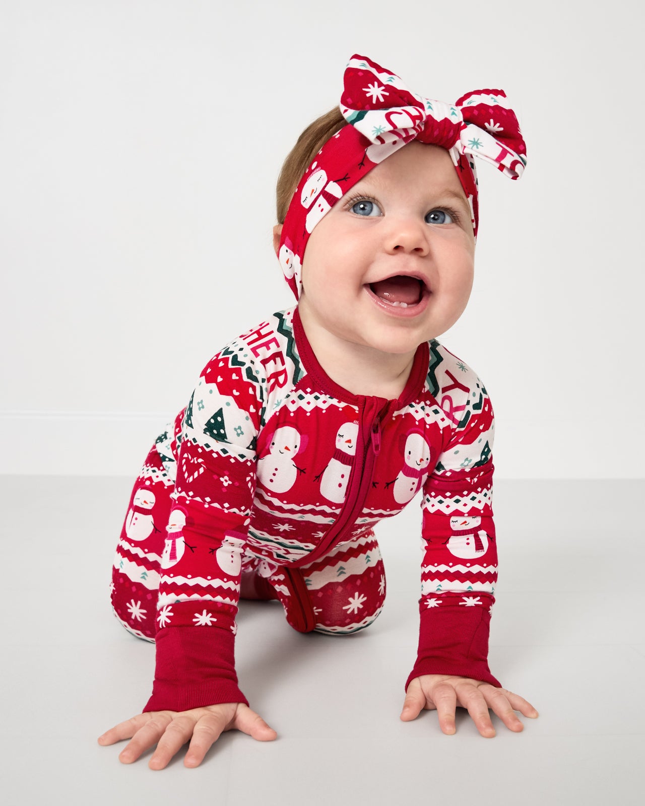 Crawling child wearing the Festive Fair Isle Zippy