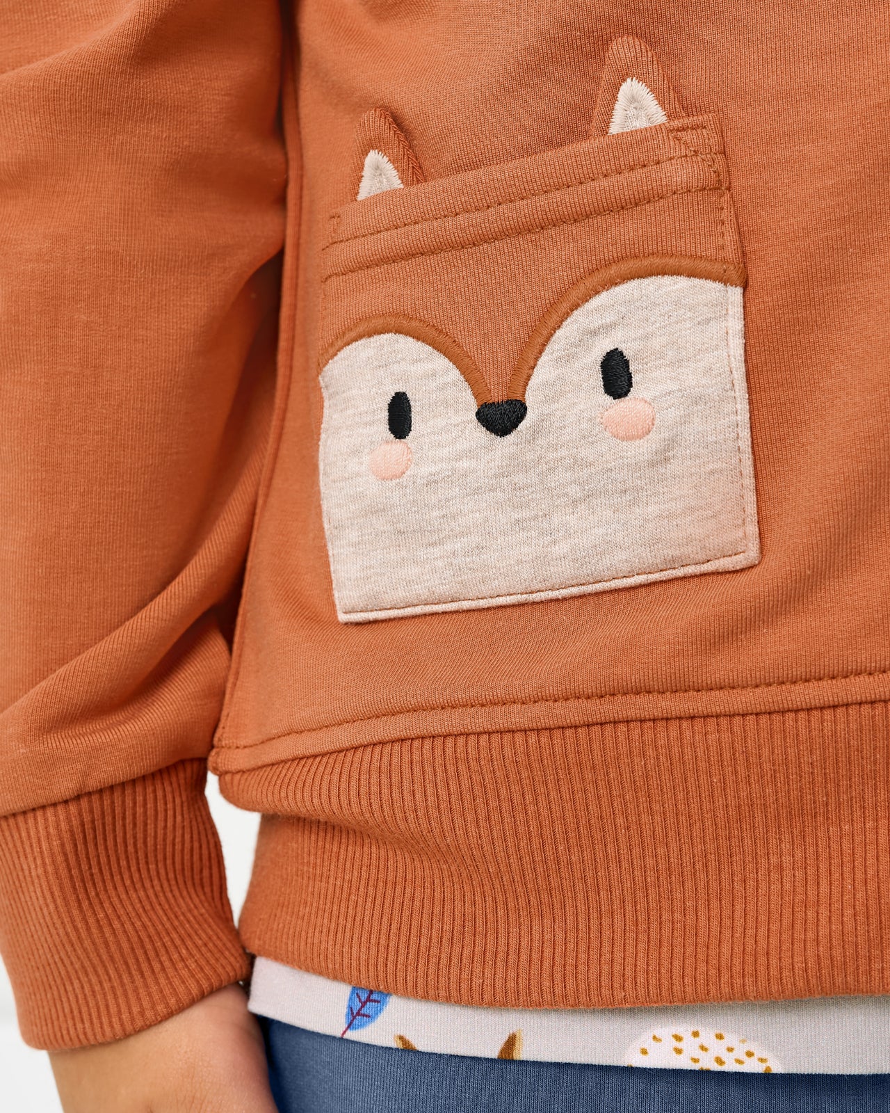 Close up of the pocket detail on the Fox Zip Hoodie
