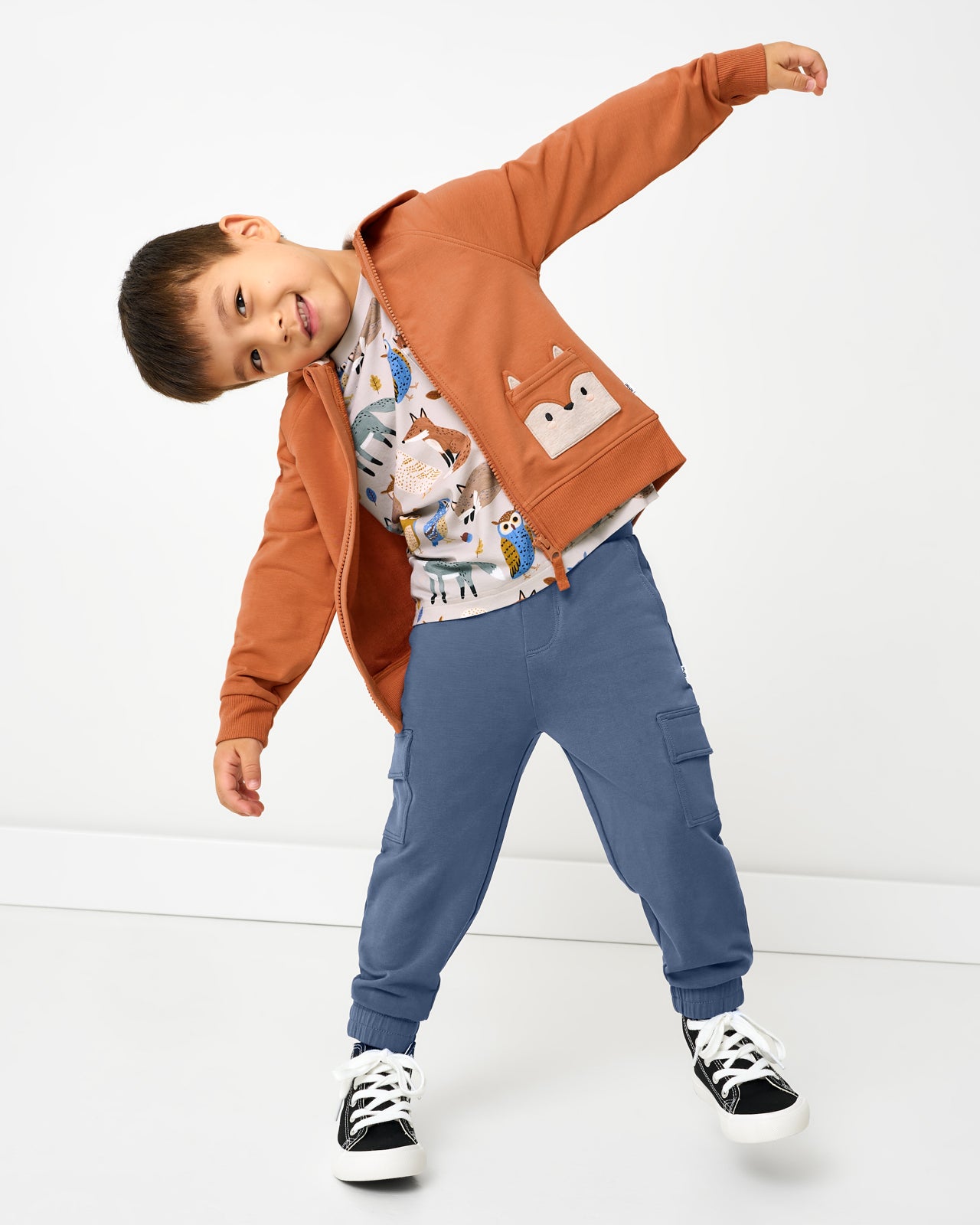 Posing boy wearing the Fox Zip Hoodie with cargo joggers