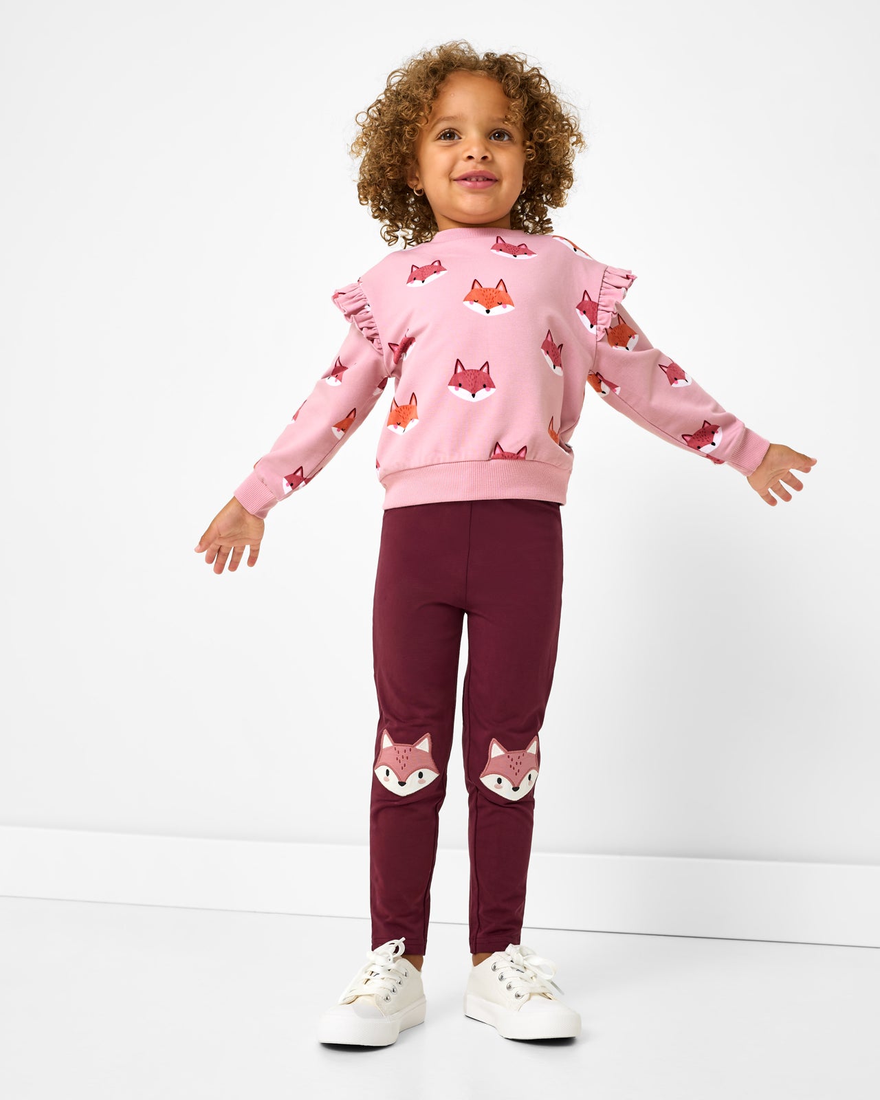 Girl wearing the Fox Tracks Flutter Crewneck with coordinating leggings