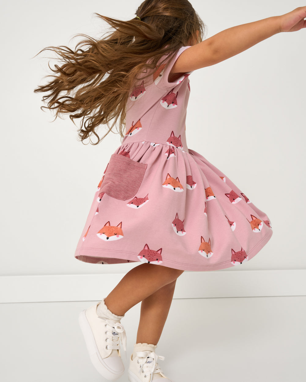 Spinning girl wearing the Pink Fox Tracks Patch Pocket Dress