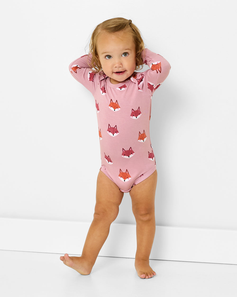 Standing toddler wearing the Fox Tracks Puff Sleeve Bodysuit