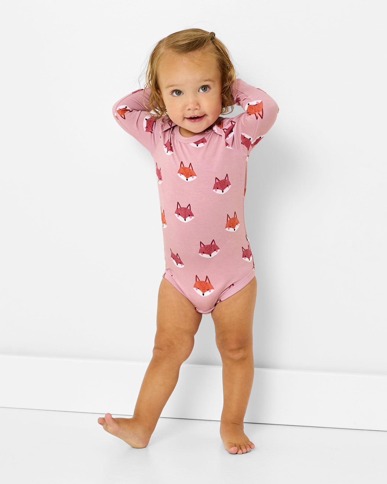 Standing toddler wearing the Fox Tracks Puff Sleeve Bodysuit