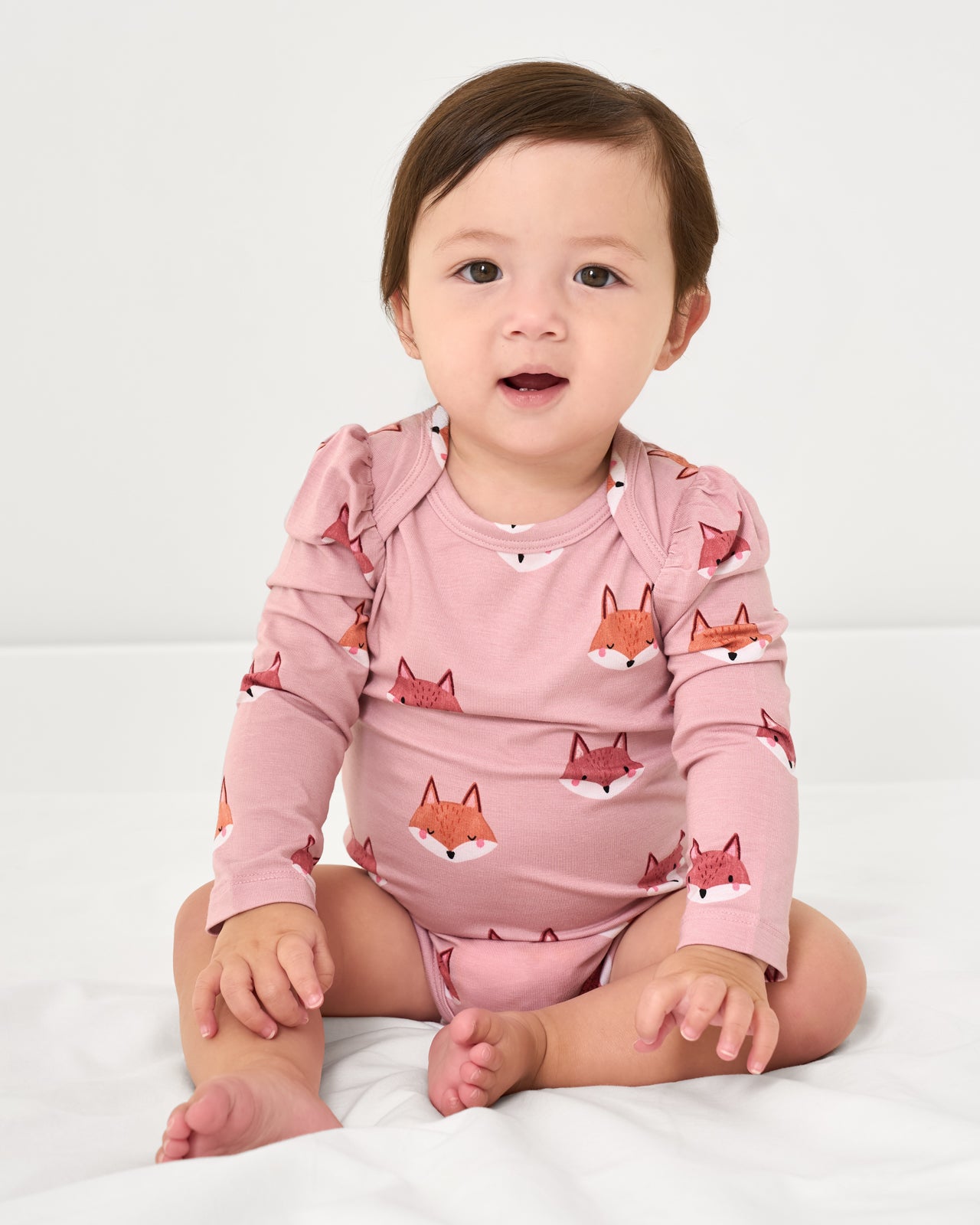 Sitting baby wearing the Fox Tracks Puff Sleeve Bodysuit