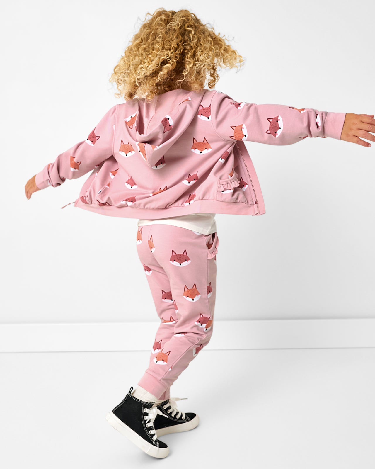 Child in motion wearing the Fox Tracks Ruffle Jogger