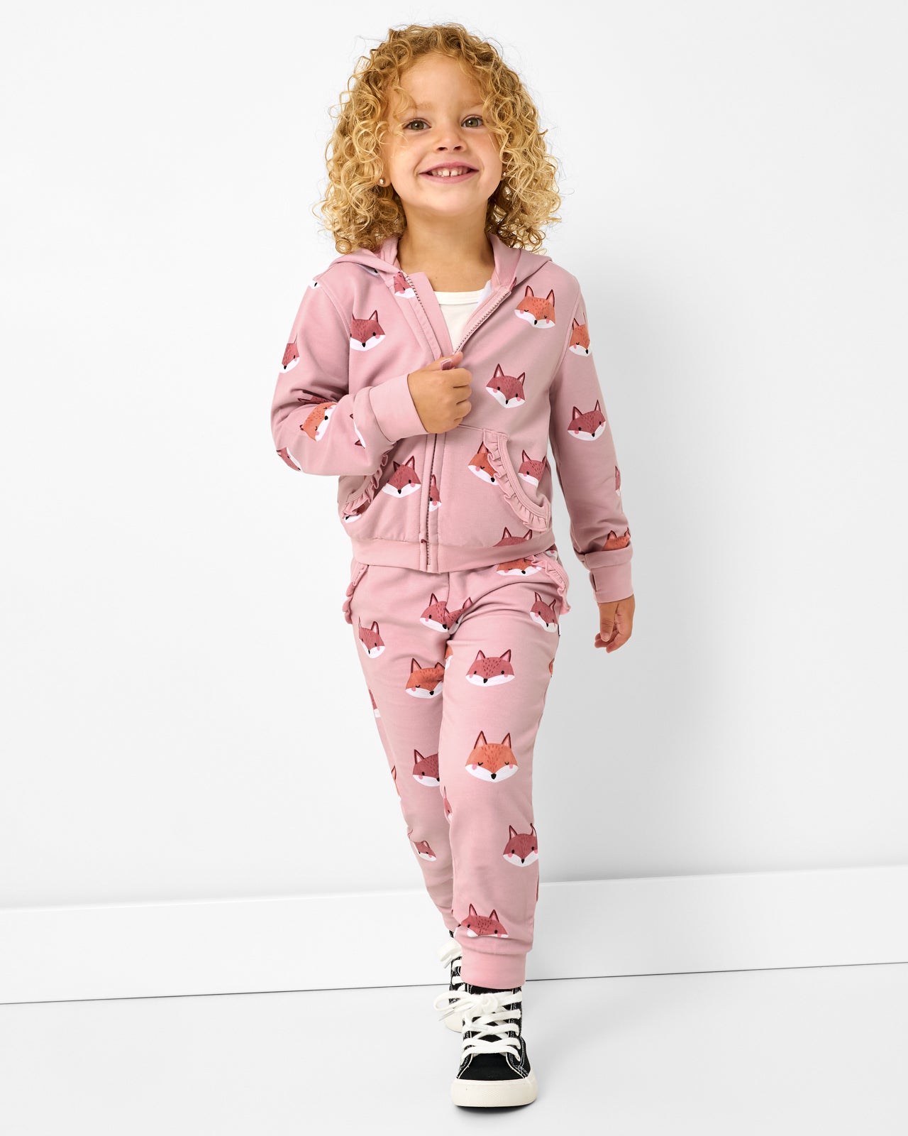 Girl wearing the Fox Tracks Ruffle Jogger with a matching zip up hoodie