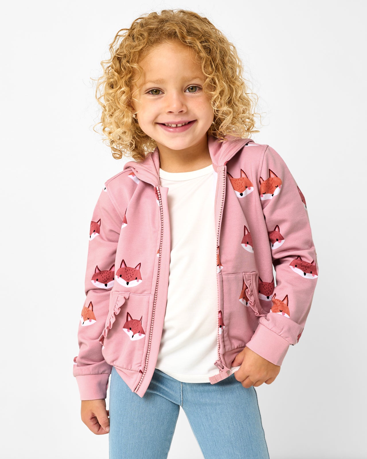 Girl wearing the Fox Tracks Ruffle Zip Hoodie layered over a white tee