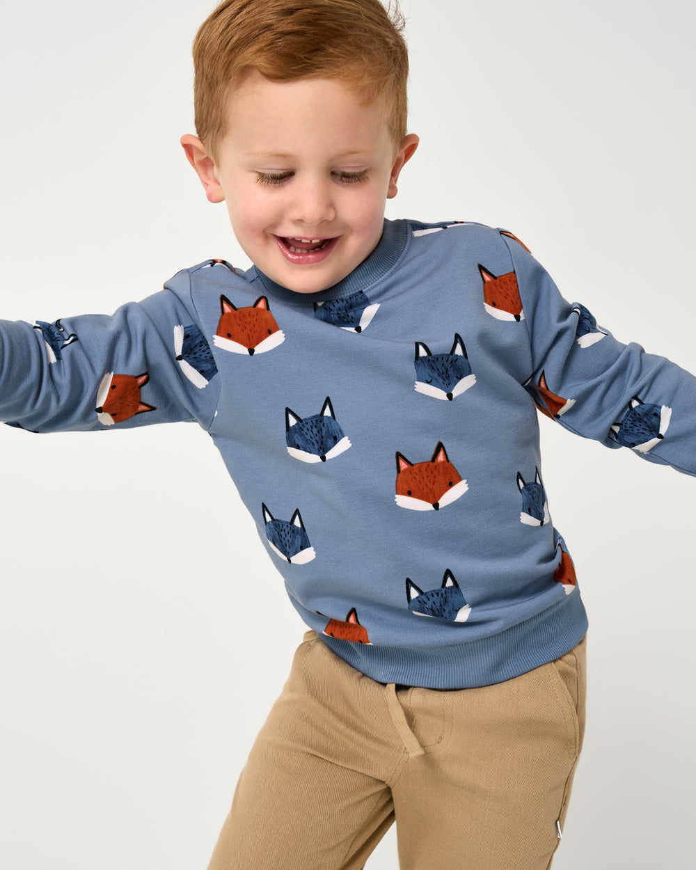 Boy wearing the Fox Tracks Crewneck Sweatshirt with khaki pants