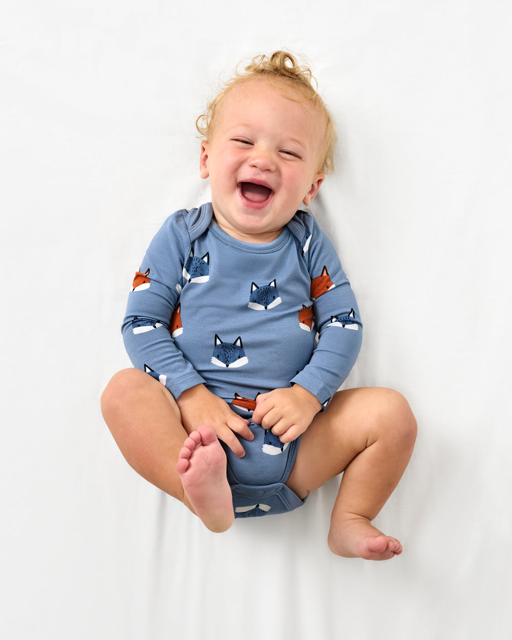 Aerial view of baby wearing the Fox Tracks Bodysuit