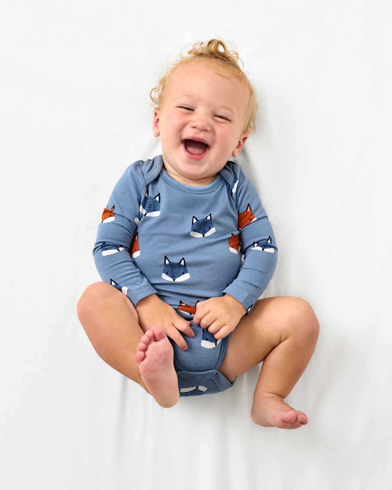 Aerial view of baby wearing the Fox Tracks Bodysuit