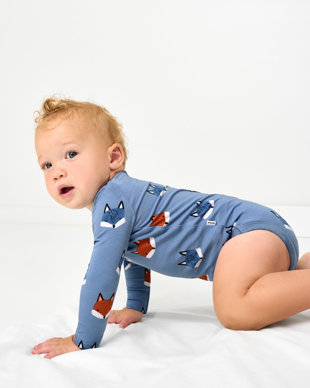 Crawling baby wearing the Fox Tracks Bodysuit