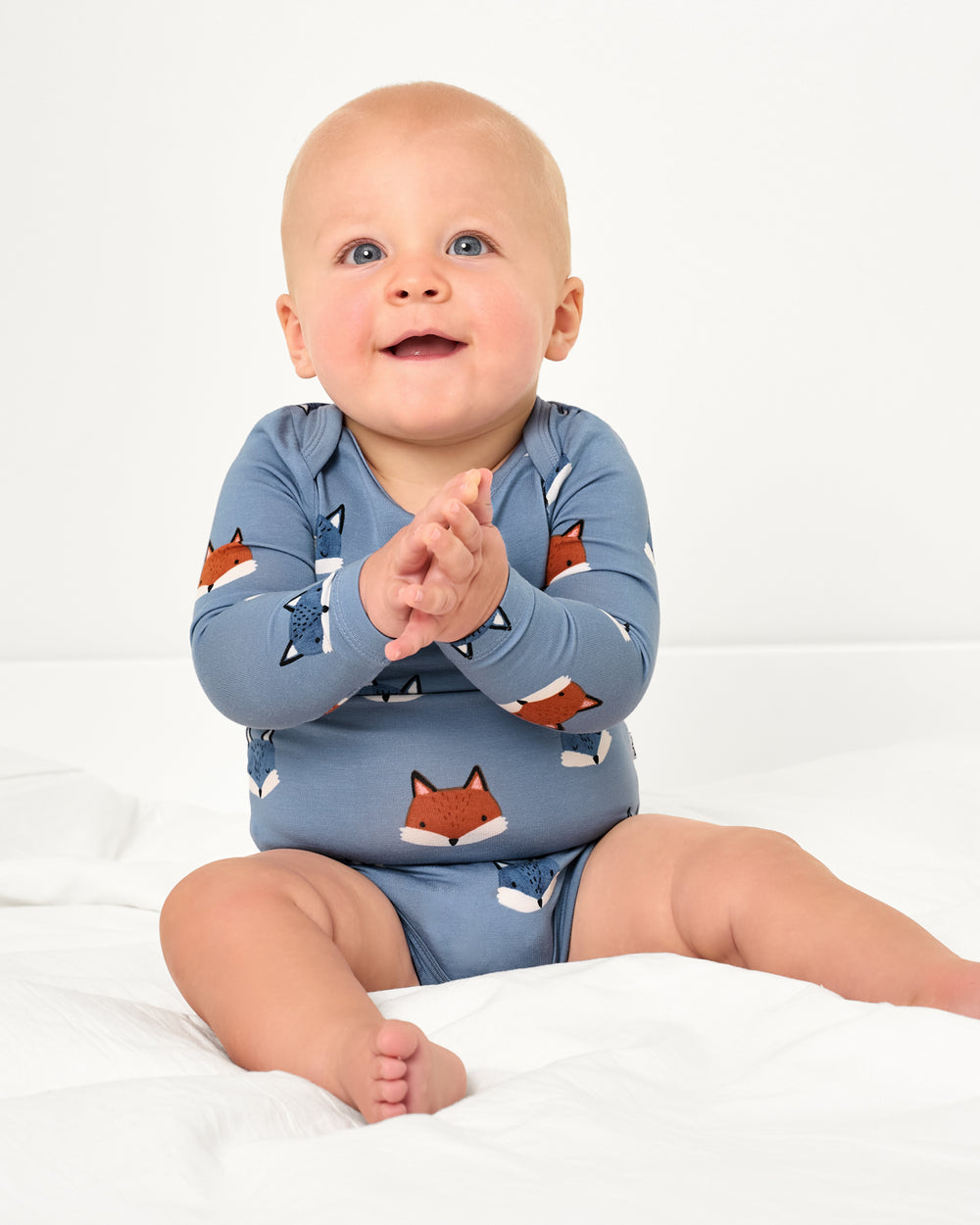 Sitting baby wearing the Fox Tracks Long Sleeve Bodysuit