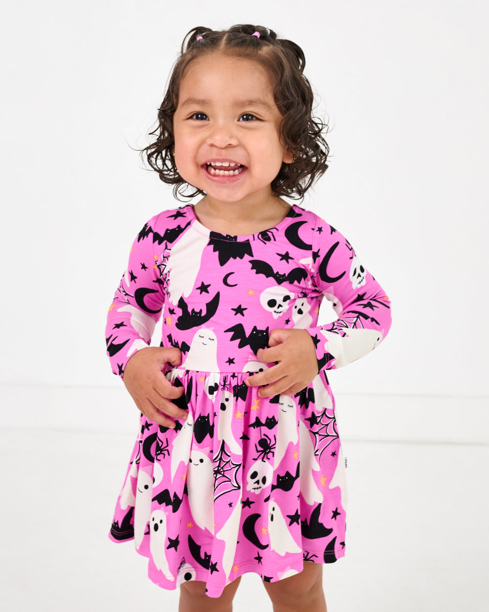 Girl wearing the Pink Frightful Friends Bow Back Skater Dress with Bodysuit