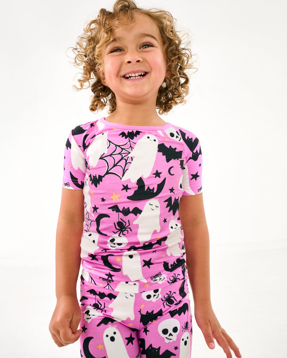 Close up of girl wearing the Pink Frightful Friends Two-Piece Short Sleeve & Shorts Pajama Set