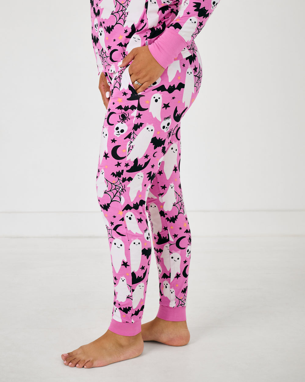 Standing woman wearing the Pink Frightful Friends Women's Pajama Pants