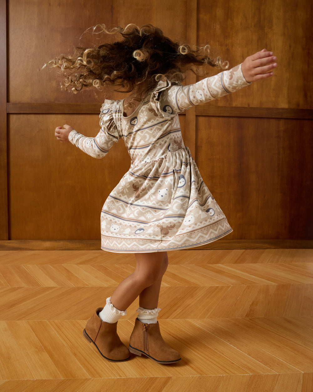 Twirling girl wearing the Frosty Fair Isle Flutter Skater Dress