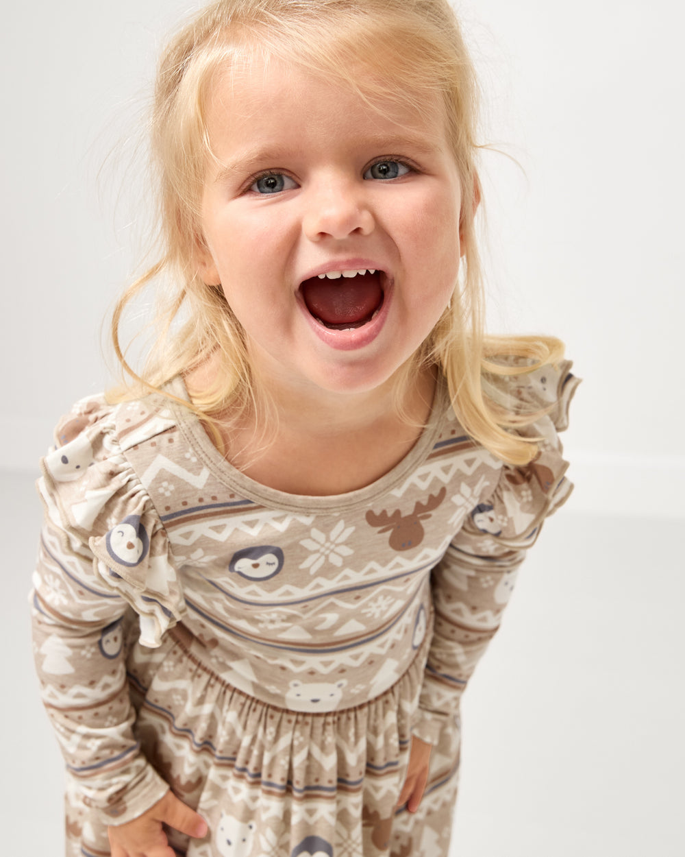 Close girl wearing the Frosty Fair Isle Flutter Skater Dress