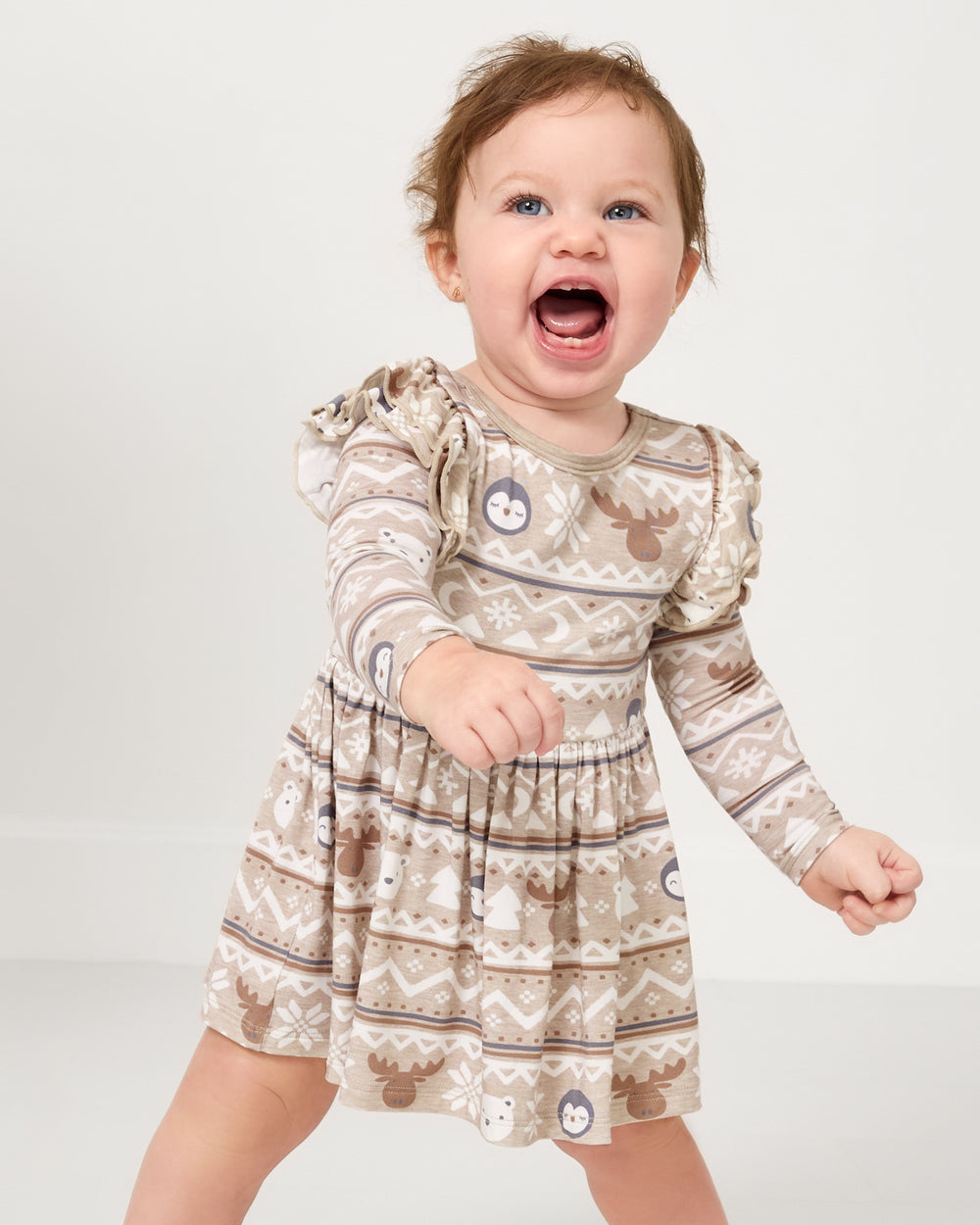 Close up of baby wearing the Frosty Fair Isle Flutter Skater Dress with Bodysuit