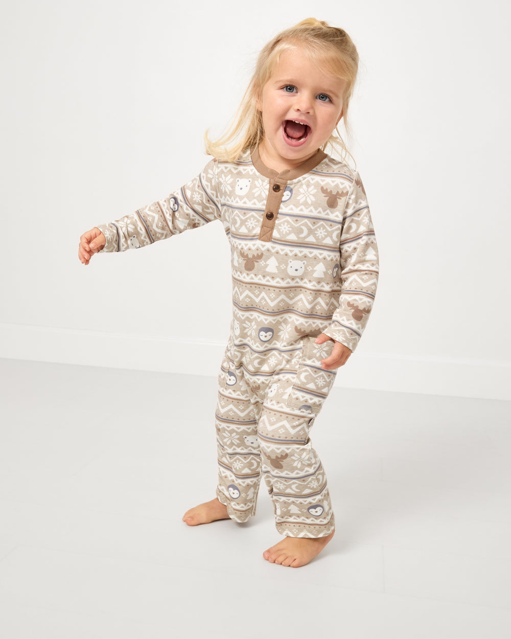 Child in motion wearing the Frosty Fair Isle Henley Romper