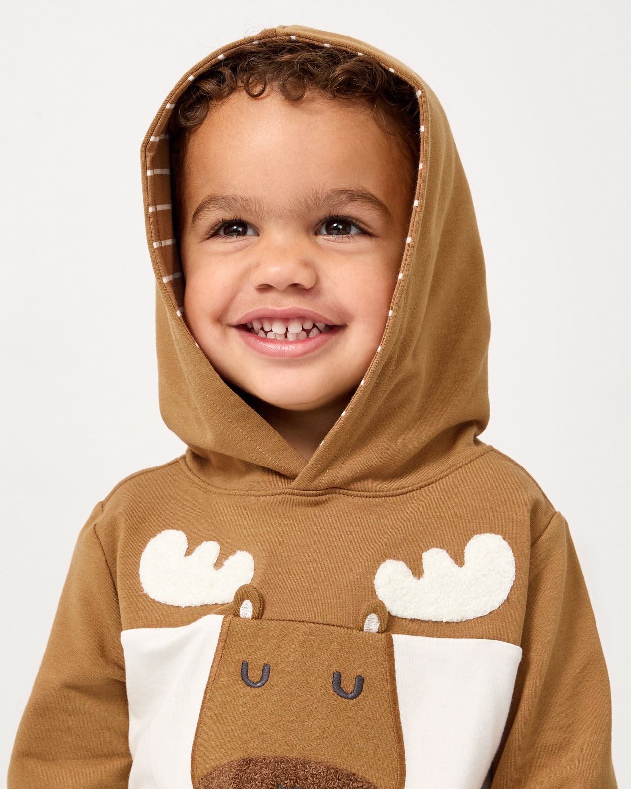 Boy wearing the Moose Pullover Hoodie with the hood on