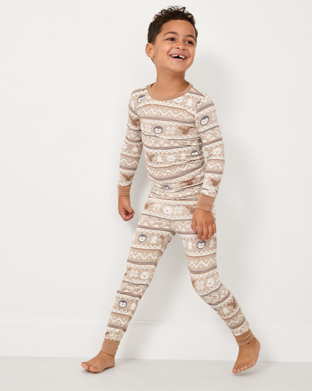 Walking boy wearing the Frosty Fair Isle Two-Piece Pajama Set