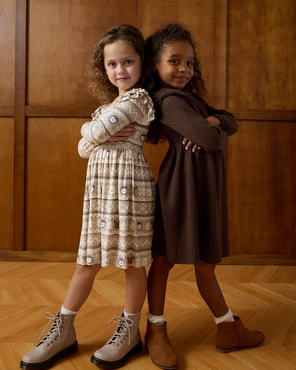 Two girls wearing dresses from the Winter Play collection