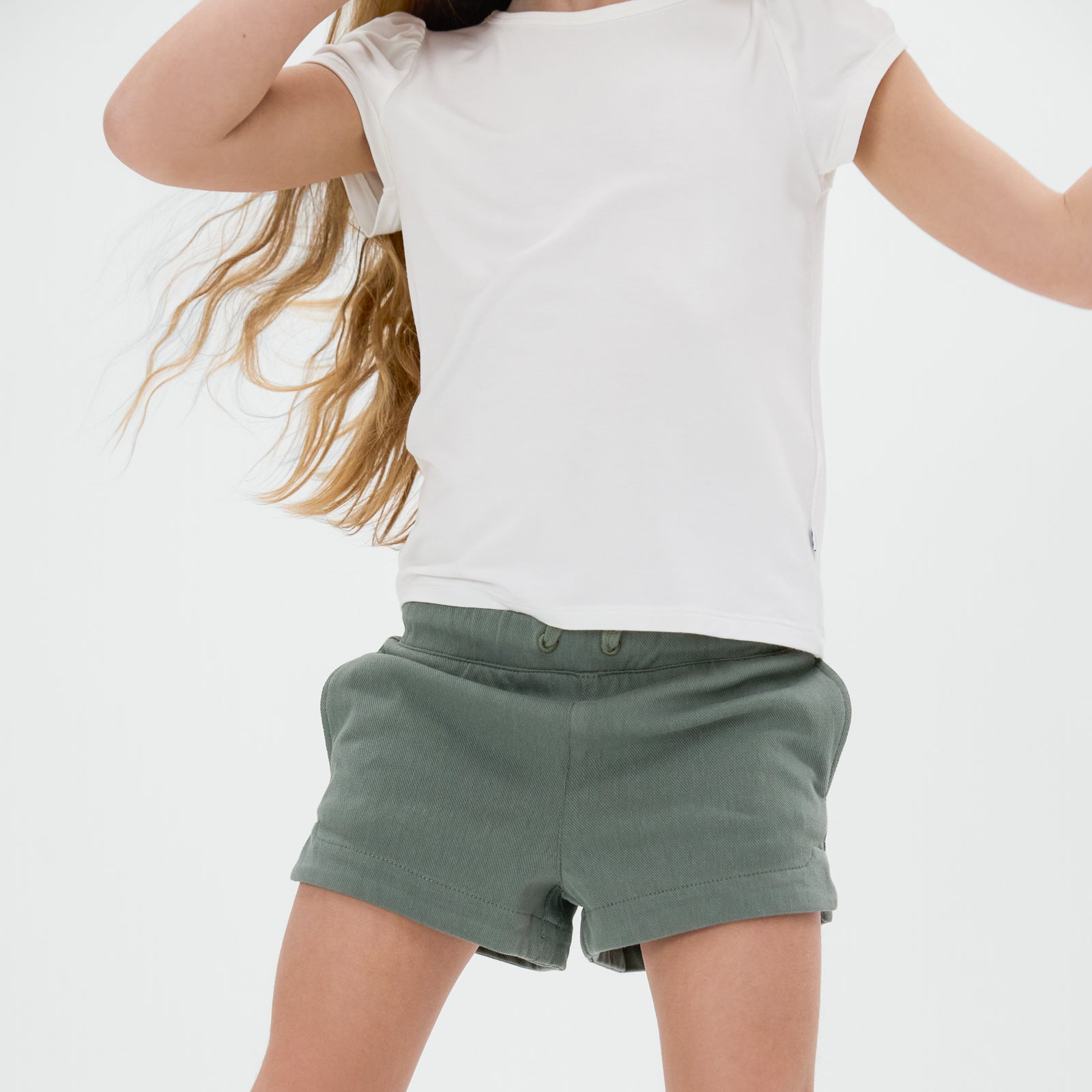 Close up of the Fern Denim Shorts paired with a bright white tee