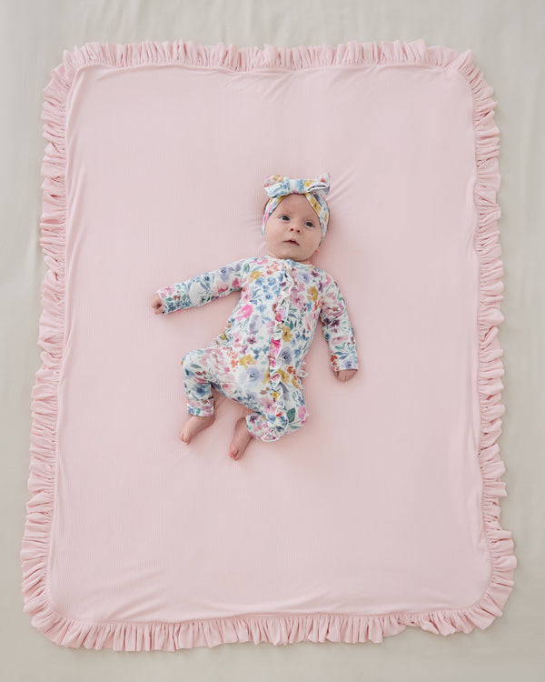 Aerial view of baby laying on the pink side  the Prima Pink Ribbed Ruffle Mini Cloud Blanket®