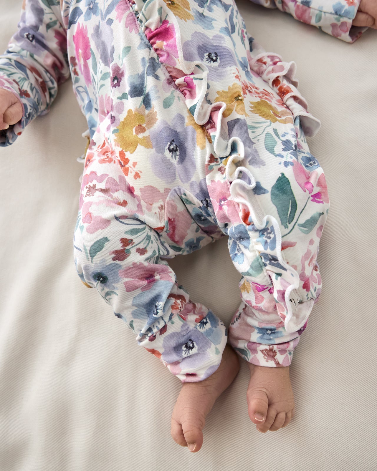 Close up of the zipper ruffle on the Tiny Blooms Ruffle Zippy