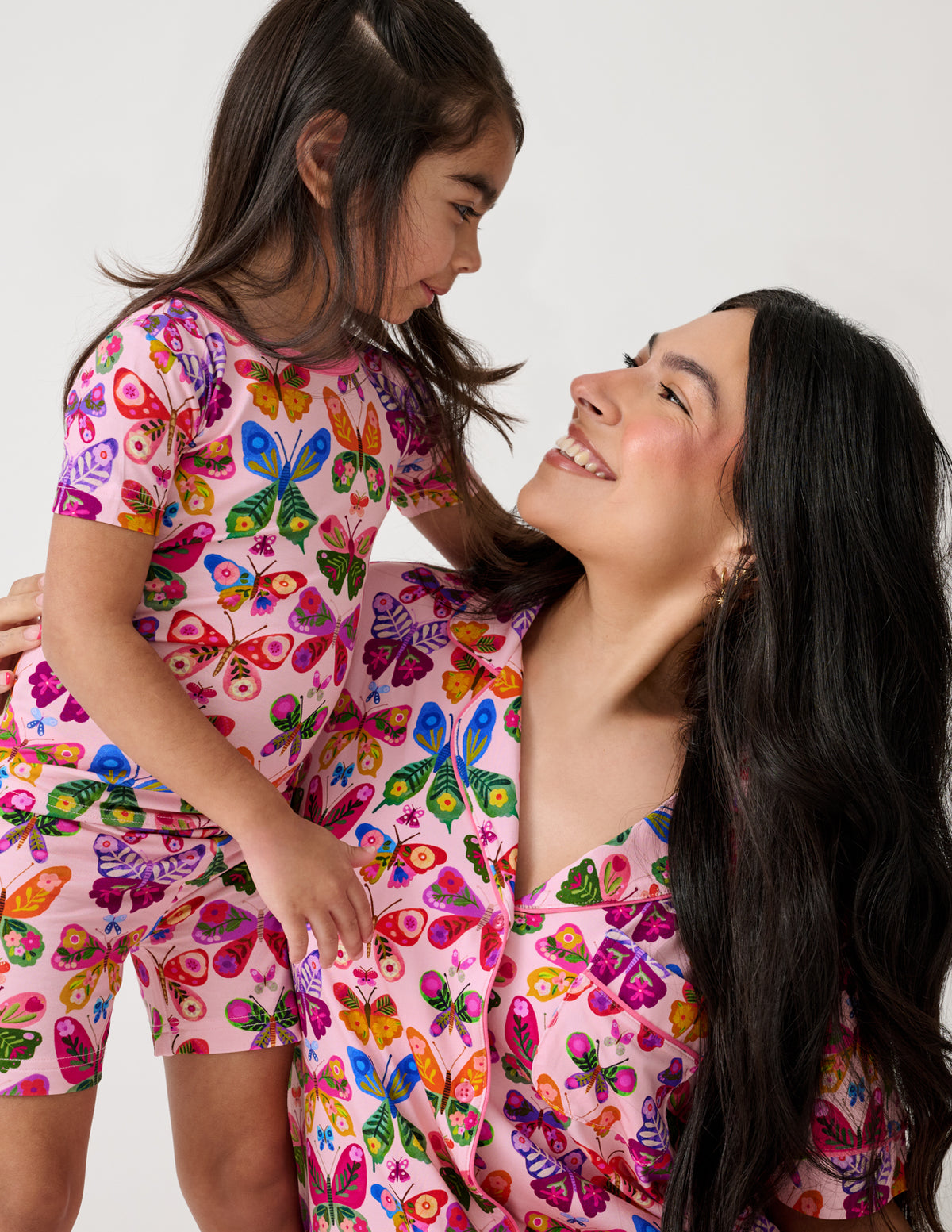 Close up of mother and daughter wearing Flutter Garden Two-Piece Short Sleeve & Shorts Pajama Sets