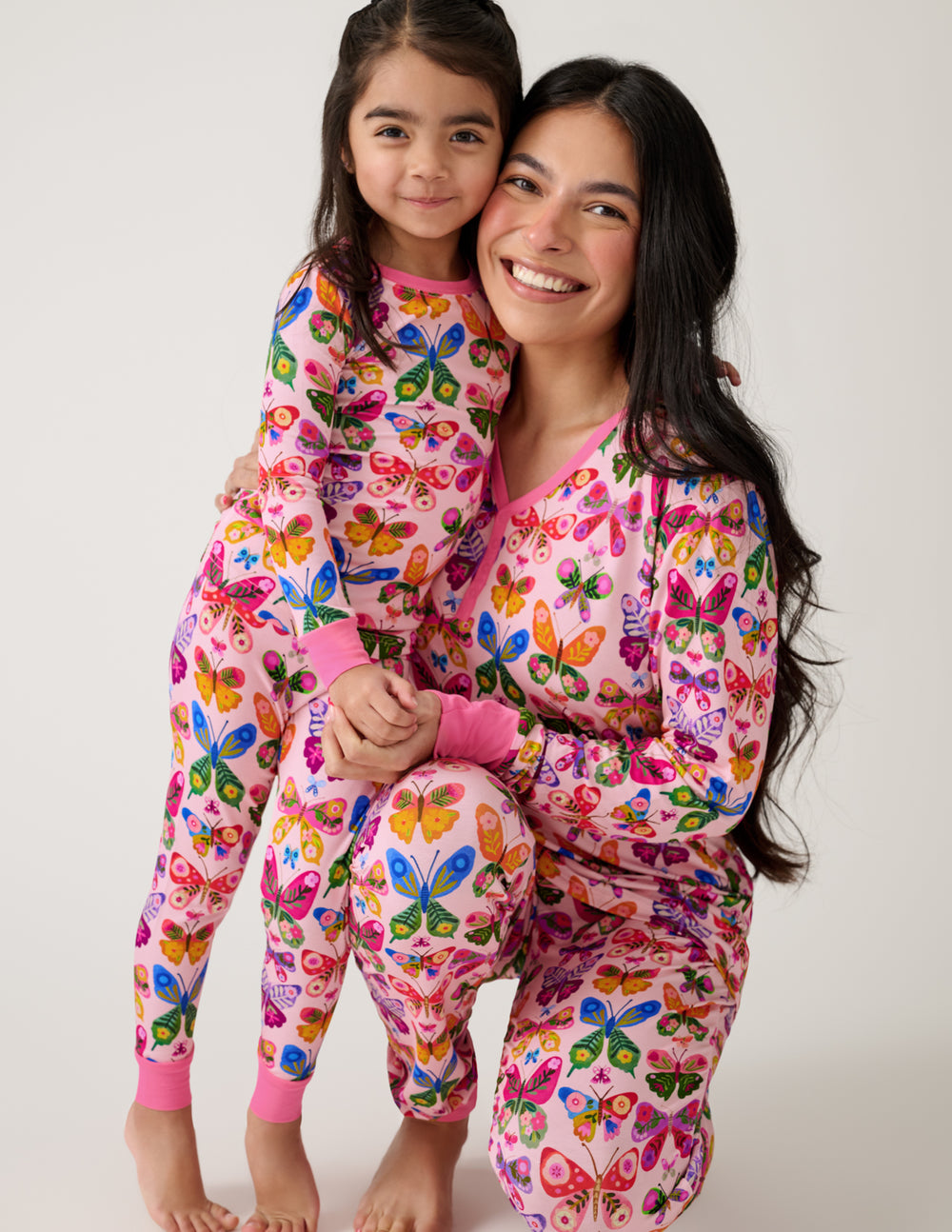 Mother and daughter wearing matching Flutter Garden butterfly print pajamas
