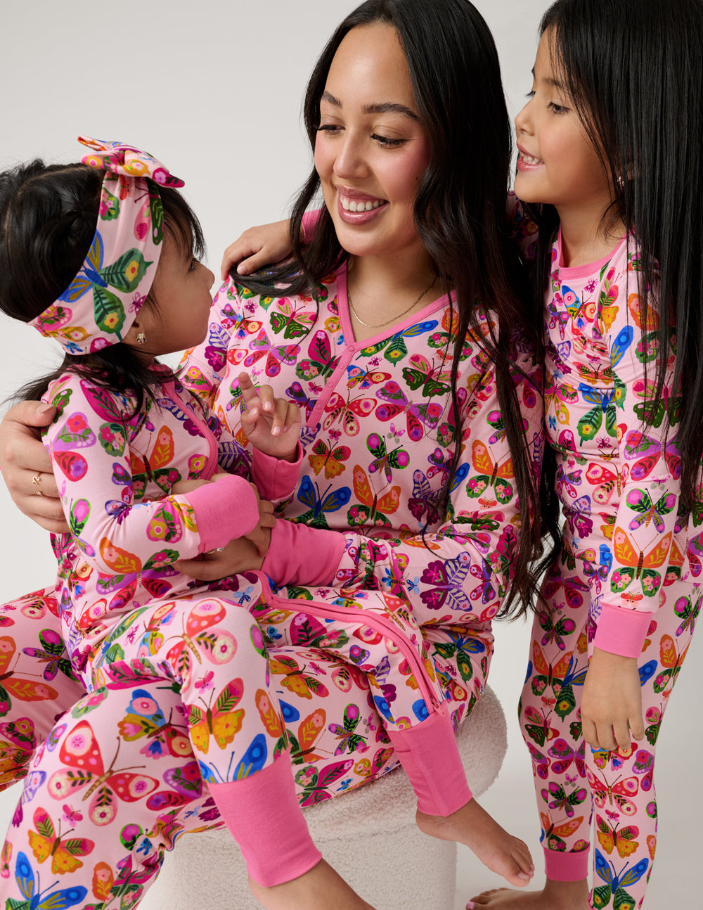 Mother and two children wearing Flutter Garden butterfly print pajamas