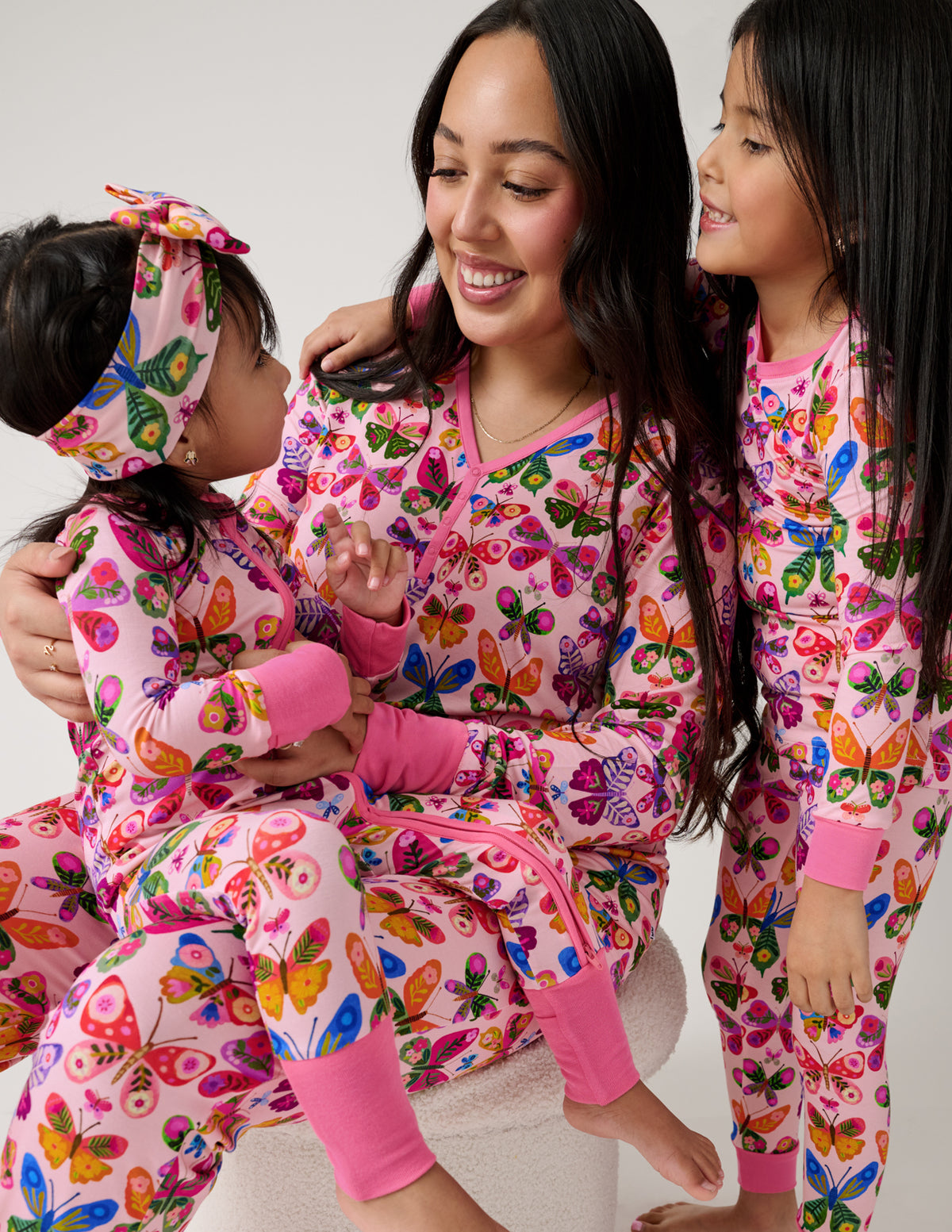 Mother and two children wearing Flutter Garden butterfly print pajamas