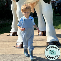 Customer Capture of a child playing wearing Fog Overalls paired with a Blue Watercolor Gingham polo shirt