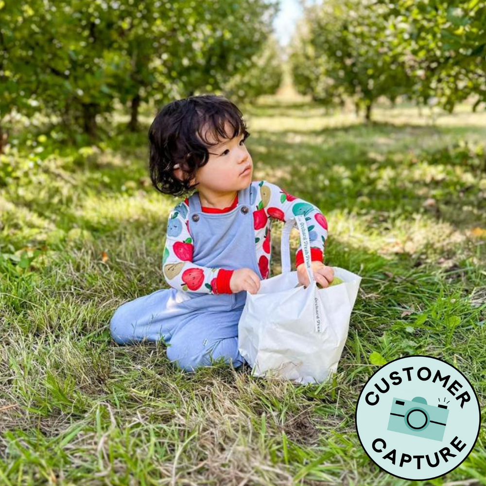 Customer Capture of a child wearing Fog Overalls paired with a Red Apple of my Eye two piece pajama top