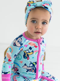 Baby girl wearing Disney Mickey's Clubhouse zippy pajamas with matching Luxe Bow.