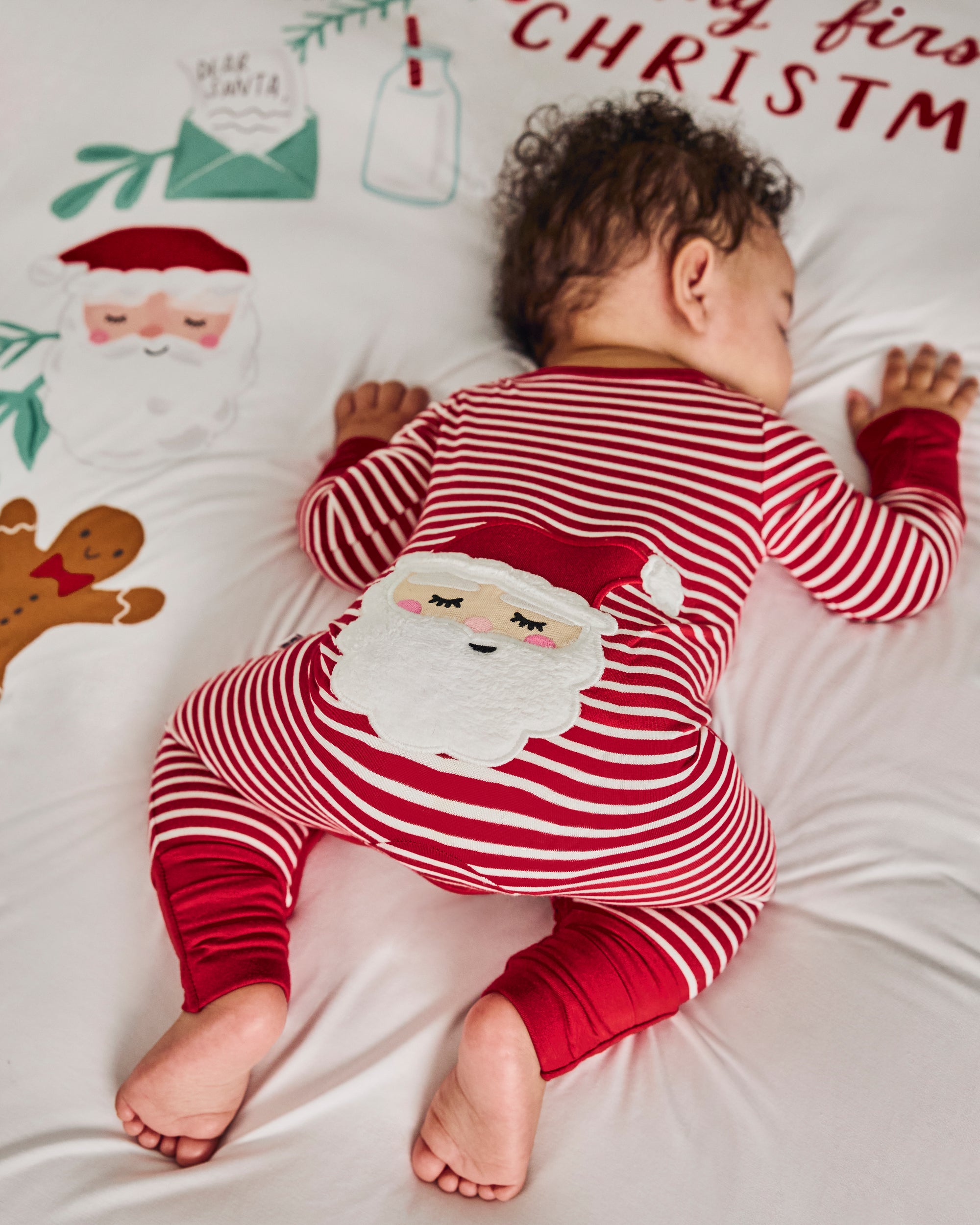 Overhead view of baby laying on the My First Christmas Milestone Plush Blanket 