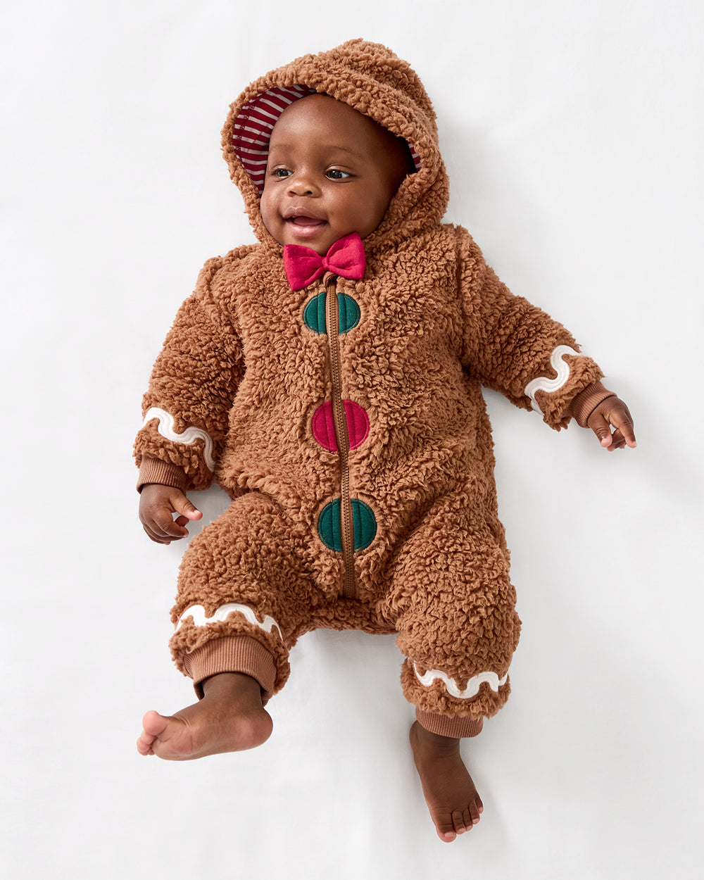 Aerial view of baby wearing the Gingerbread Sherpa Romper